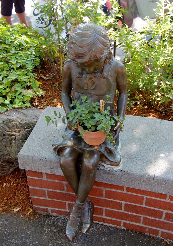 little bronze girl with plant