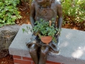 little bronze girl with plant